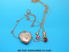 Two 9ct gold pendants one set with rubies and a central diamond and the other a garnet,