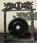A carved hardwood gong with dragon finial decoration