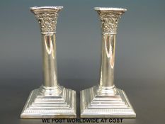 A pair of hallmarked silver Corinthian column candle sticks, Sheffield 1915, Martin Hall & Co.