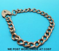 A 9ct gold bracelet with 9ct gold heart padlock (10.