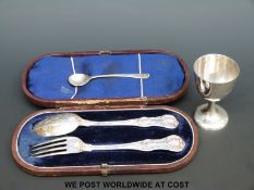A cased Victorian hallmarked silver fork and spoon set and Chinese egg cup and spoon marked 90%