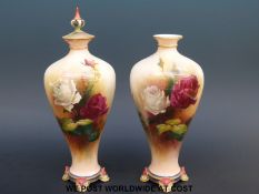 A pair of Royal Worcester vases hand-decorated with roses,