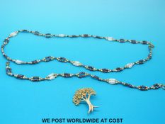 A beaded necklace and bracelet made up of pearls and garnets and a 9ct gold brooch in the form of a