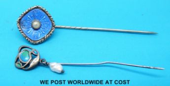 A hallmarked silver stick pin by Liberty & Co set with enamel and a drop pearl together with a