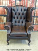 A leather Chesterfield wing backed armchair