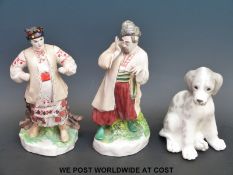 A pair of Russian porcelain figures and a Lomonosov dog