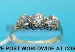 An 18ct gold ring set with three round brilliant cut diamonds,