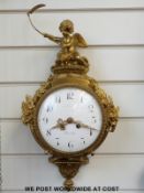 A 19thC French brass wall clock in the Rococo style, with enamelled dial and two-train movement,