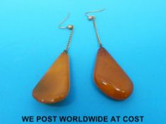 A pair of vintage amber earrings with yellow metal fittings