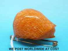 An amber brooch in the form of a hedgehog