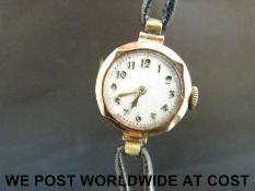 Art Deco 9ct gold ladies wristwatch with gold hands and Arabic numerals on striped face,