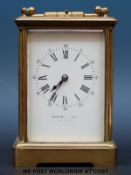 A c1910 French brass repeater carriage clock, repeating on the half hour, oval glass to top,