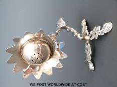 A white metal pepper or pot pourri formed as a flower,