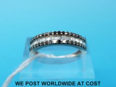 A 9ct white gold ring set with baguette cut diamonds and round black diamonds