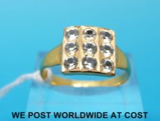 A yellow metal ring set with nine white sapphires in a square setting (size S)
