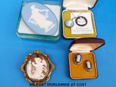 A large cameo depicting a cherub praying in a gilt brooch, a large Wedgwood Jasper ware brooch,