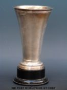 A silver trumpet vase with hammered design in the Arts & Crafts style,