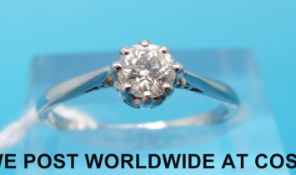 A platinum ring set with a round brilliant cut diamond measuring approximately 0.