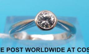 An 18ct white gold ring set with a round brilliant cut solitaire diamond of approximately 0.