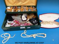 A jewellery box containing two ivory necklaces,