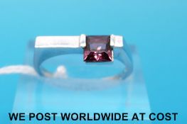 A white metal ring marked 14k set with pink tourmaline (size N)