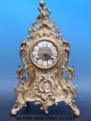 A Dutch style mantel clock in a Rococo brass ormolu style case,