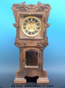 A 19thC German carved clock in Arts & Crafts style case, four bevelled glass panels,