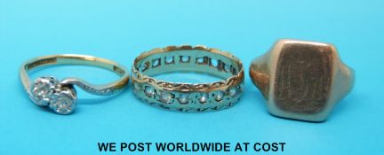 An 18ct gold ring set with diamonds in a crossover design together with a 9ct gold eternity ring