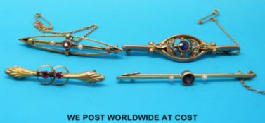 Four yellow metal bar brooches set with seed pearls, garnets and one with an amethyst,