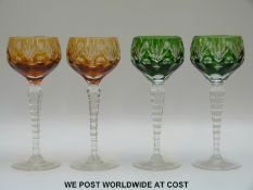 Two pairs of harlequin flash overlaid hock glasses with cut decoration to the bowls,