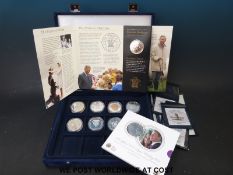 Nine silver crown sized Royal commemorative coins in a Westminster case,