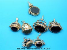 Six 9ct gold swivel fobs set with agate and blood stone and a similar Victorian fob