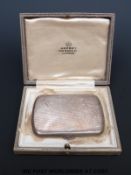 A cased Asprey hallmarked silver compact, engraved with the signature 'C.