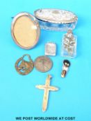 A yellow metal cross, hallmarked silver photo frame, hallmarked silver locket,