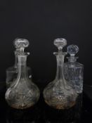 Four glass decanters comprising a ship's style example with four masted ship engraved,