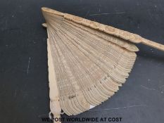 An unusually large Chinese or Canton carved ivory brise fan,