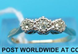 A yellow metal ring marked 18ct set with three diamonds in a platinum illusion setting (size N)