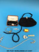 A collection of jewellery to include a 9ct gold watch, silver sweetheart brooch, beads etc.