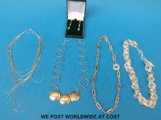 Four silver necklaces and a pair of silver earrings set with opals