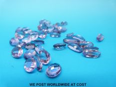 A packet of loose oval cut amethysts