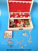 A collection of costume jewellery to include three silver necklaces, ceramic pendant, brooches,
