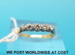 A yellow metal ring marked 18ct set with five diamonds (size J)