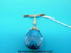 An 18ct white gold brooch set with seed pearls and diamonds with a large drop blue paste stone