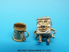 Two 9ct gold charms, one a tankard with the remains of enamel decoration,