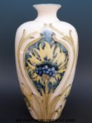A possibly Moorcroft Macintyre vase with revived cornflower design,