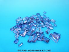 A packet of emerald cut and square cut amethysts