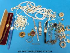 A collection of costume jewellery to include a three strand pearl necklace, watches,