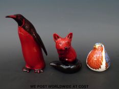 A Royal Doulton flambe fox and penguin and a Royal Crown Derby robin