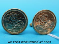 A pair of 9ct gold cufflinks each set with a year 2000 gold half sovereign (14.
