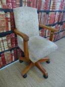 An upholstered Captain's swivel chair